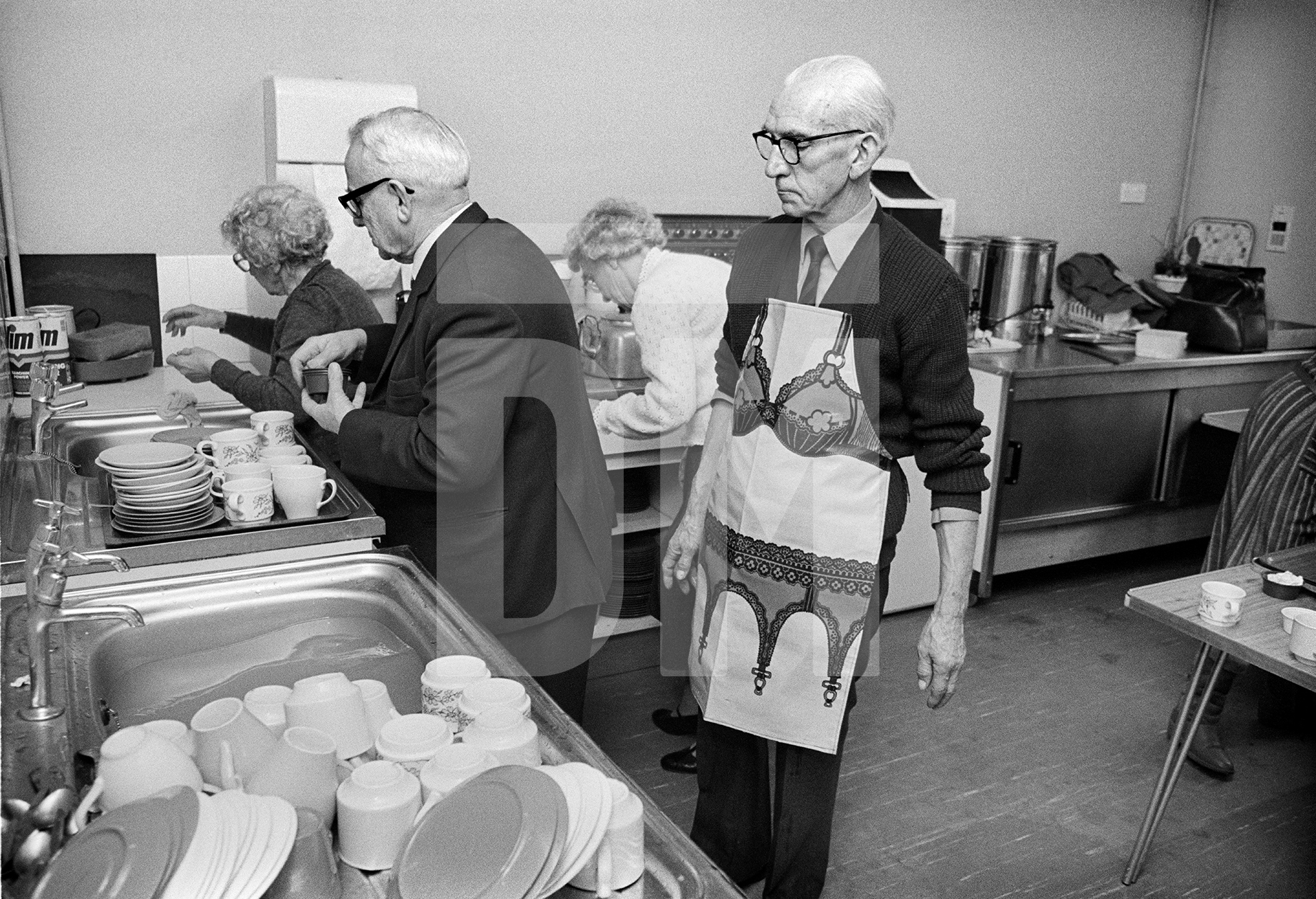 Washing-up. Civil Service Retirement Fellowship, village hall. Orpington, Kent. February 1985 by Daniel Meadows