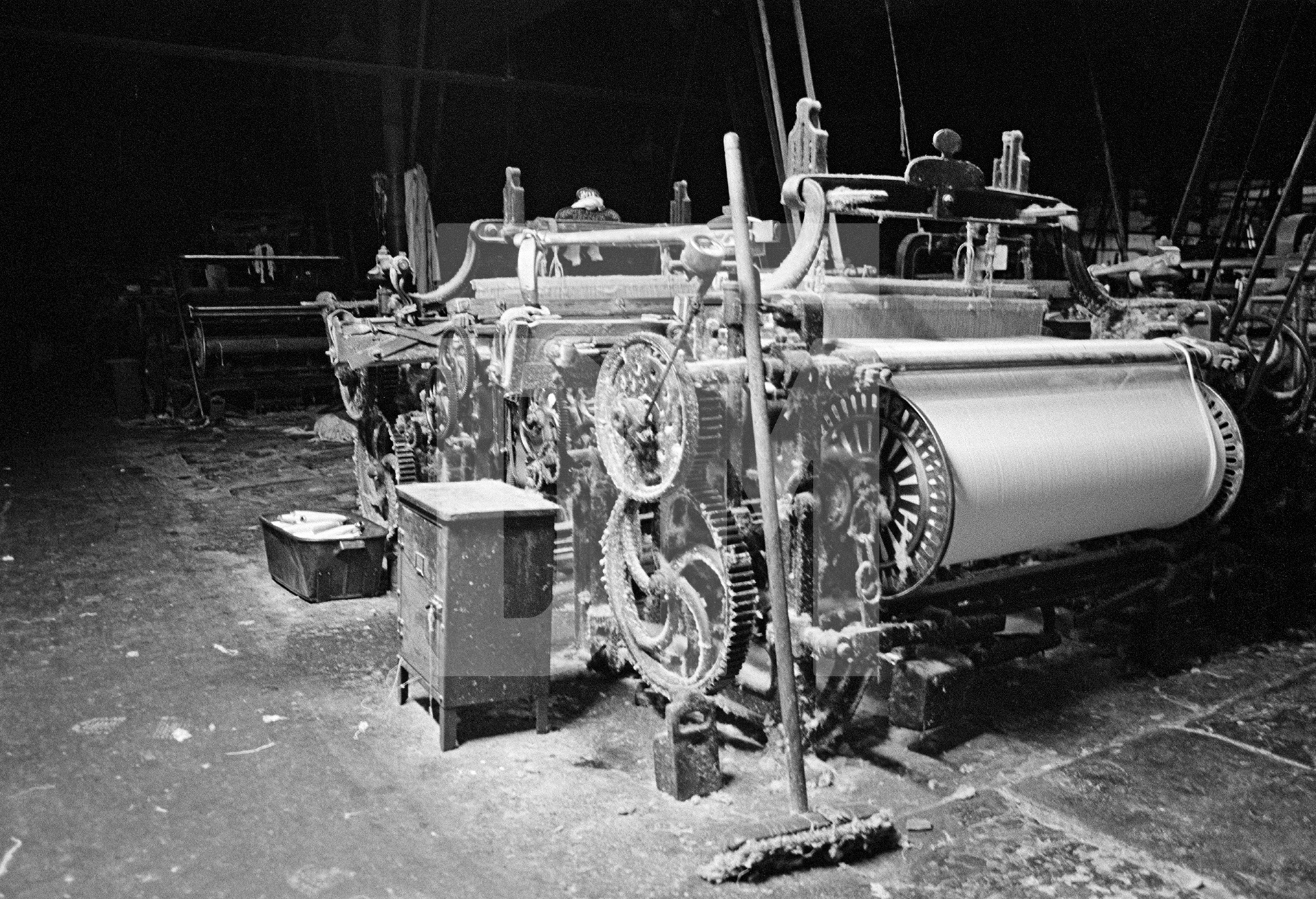 In the weaving shed, loom after dark. Silent, Sunday evening. September 1976 by Daniel Meadows