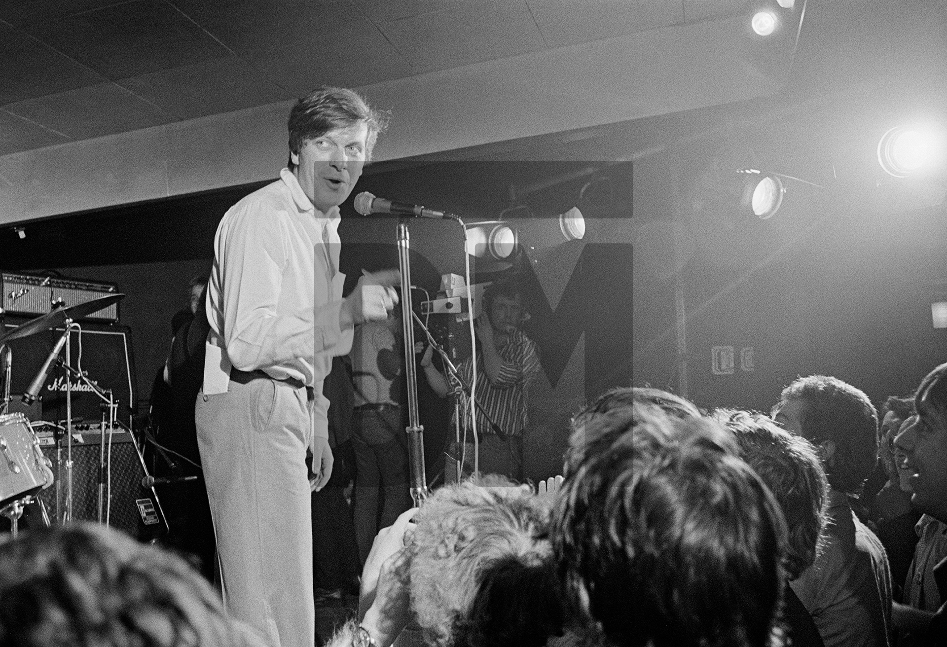 Tony Wilson at the Russell Club for a ‘Factory’ night. ‘What's On’ from Granada TV on location, Hulme, Manchester. April 1979 by Daniel Meadows