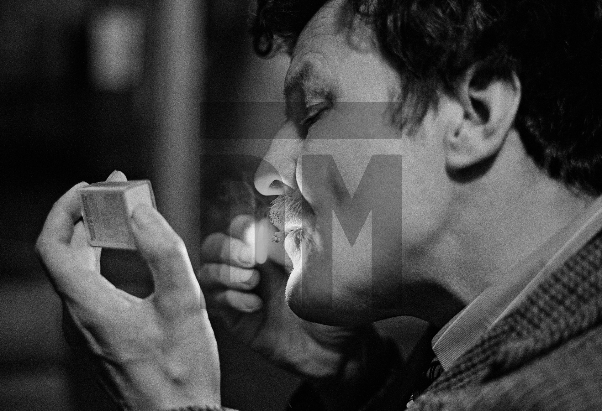 Arthur Shaw, aged 56 once an apprentice brass finisher who was admitted in 1943, lights the stub of a cigarette. He holds mumbled conversations with green men he sees on the walls and he steals other people’s tokens. February 1978 by Daniel Meadows