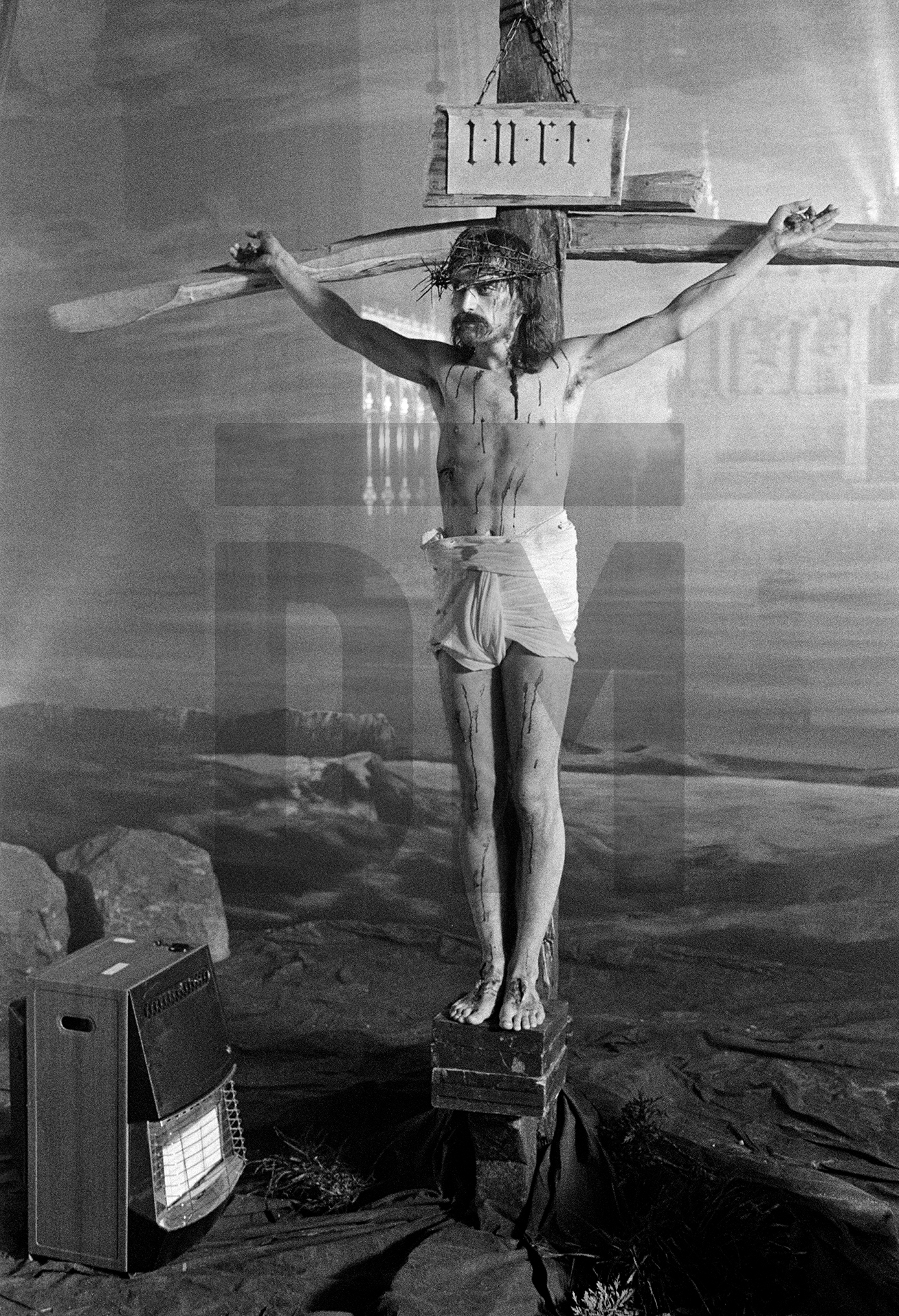 Paul Waggett [Christ] from Southport, a social security appeals tribunal clerk, in the Crucifixion scene, on the set at St Francis Xavier church, Everton. Tony Palmer’s ‘Hindemith’ for LWT’s South Bank Show, March 1989 by Daniel Meadows
