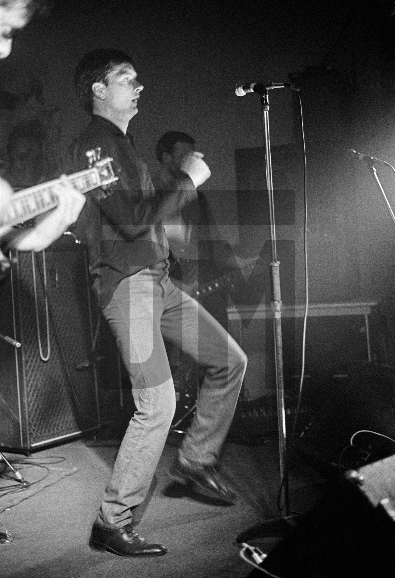 Ian Curtis of Joy Division on stage at New Osbourne Club, Miles Platting, Manchester. 7 February 1980 by Daniel Meadows