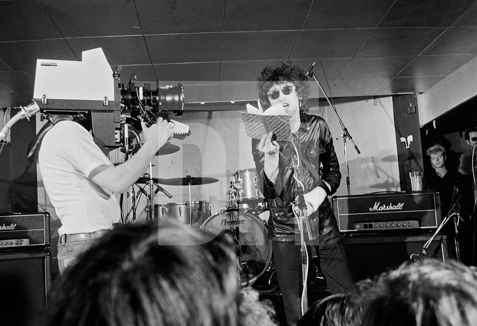 John Cooper Clarke at the Russell Club, Hulme, for a ‘Factory’ night. 'What's On' programme from Granada TV on location. April 1979 by Daniel Meadows
