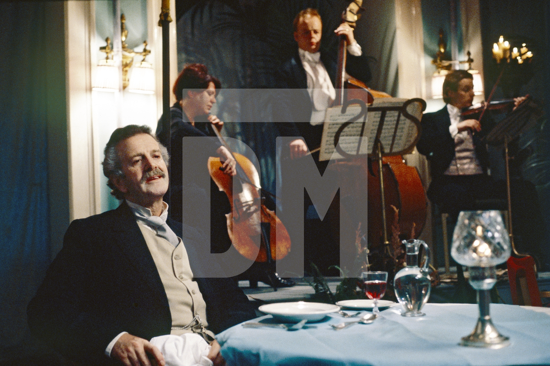 Aschenbach [Robert Gard] watches Tadzio’s family arrive for dinner at the hotel in Venice. Location filming. Charing Cross Hotel, London. 15 June 1981 by Daniel Meadows