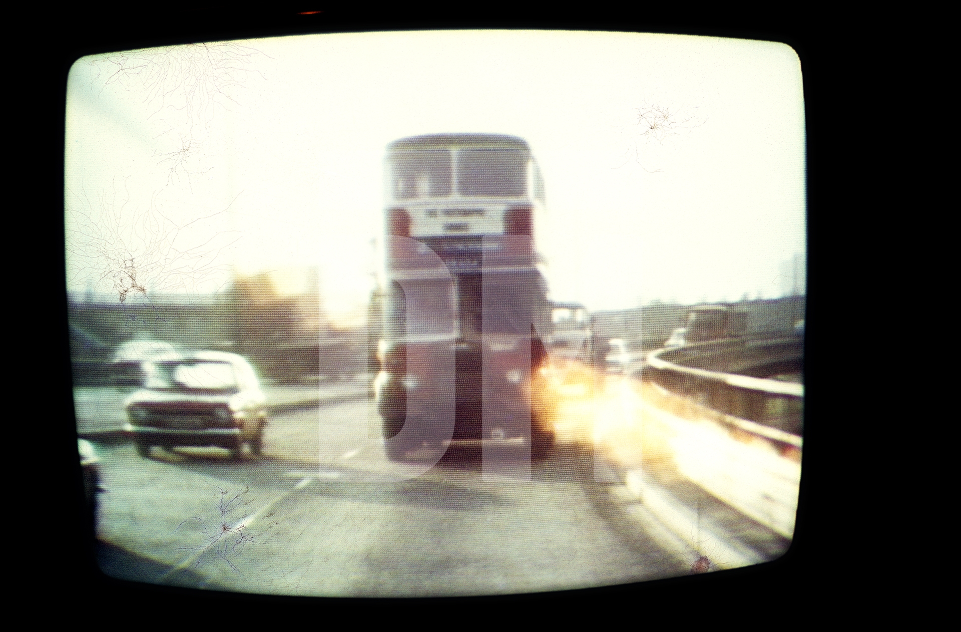 Free Photographic Omnibus as seen on TV, Granada Reports, driving along the Mancunian Way, Manchester. 7 February 1974 by Daniel Meadows
