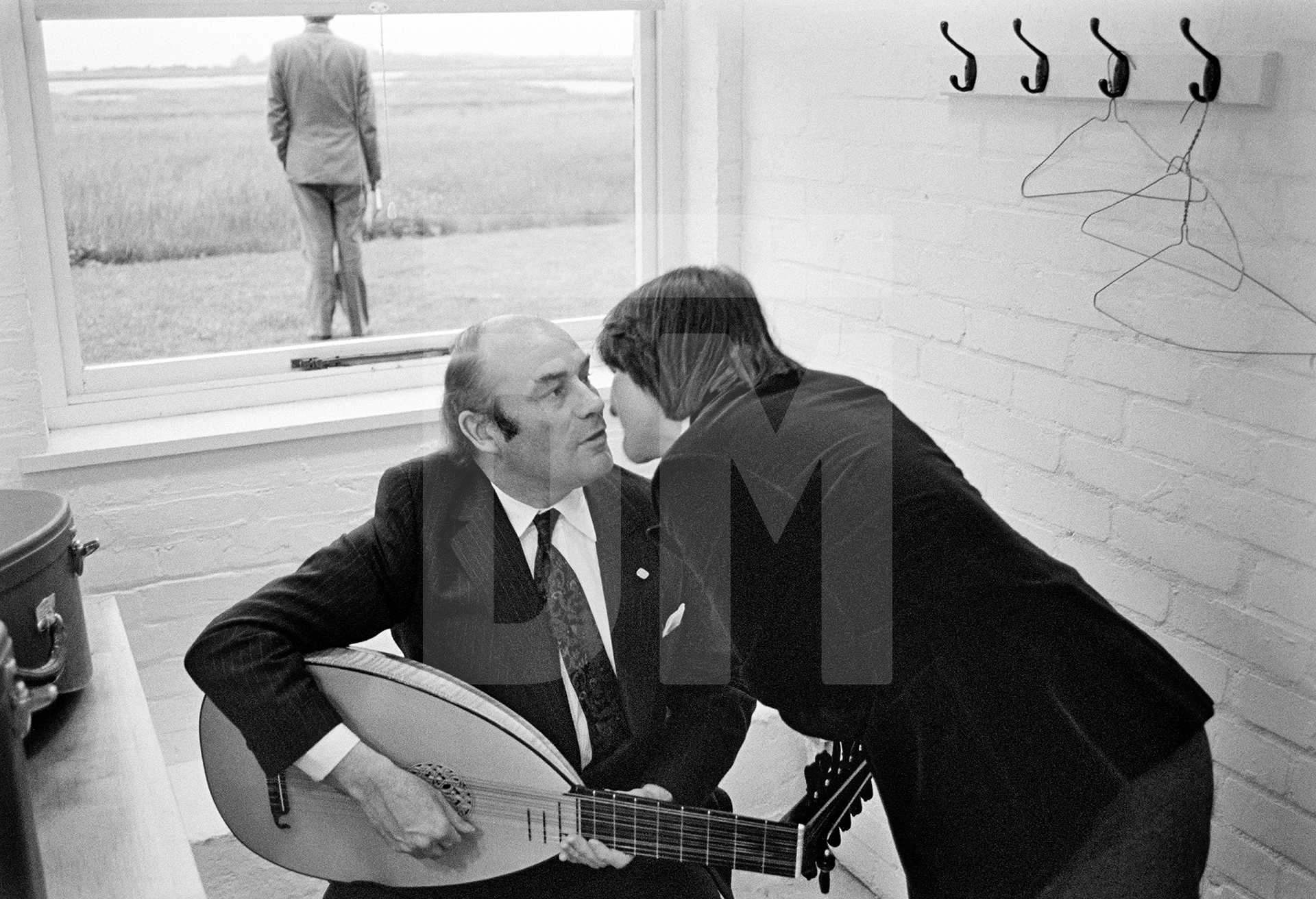 Julian Bream with lute in his dressing room at Snape Maltings Concert Hall, Suffolk.  June 1981 by Daniel Meadows
