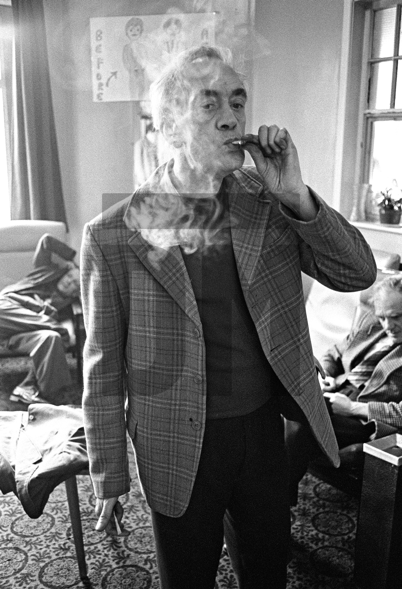 Stanley Massey, aged 57, smokes a ‘toilet roll Havana’, the nickname given to cigarettes made from 'dimps' (fag-ends) with paper ripped from the lining of a cigarette packet or, failing that, a toilet roll. February 1978 by Daniel Meadows