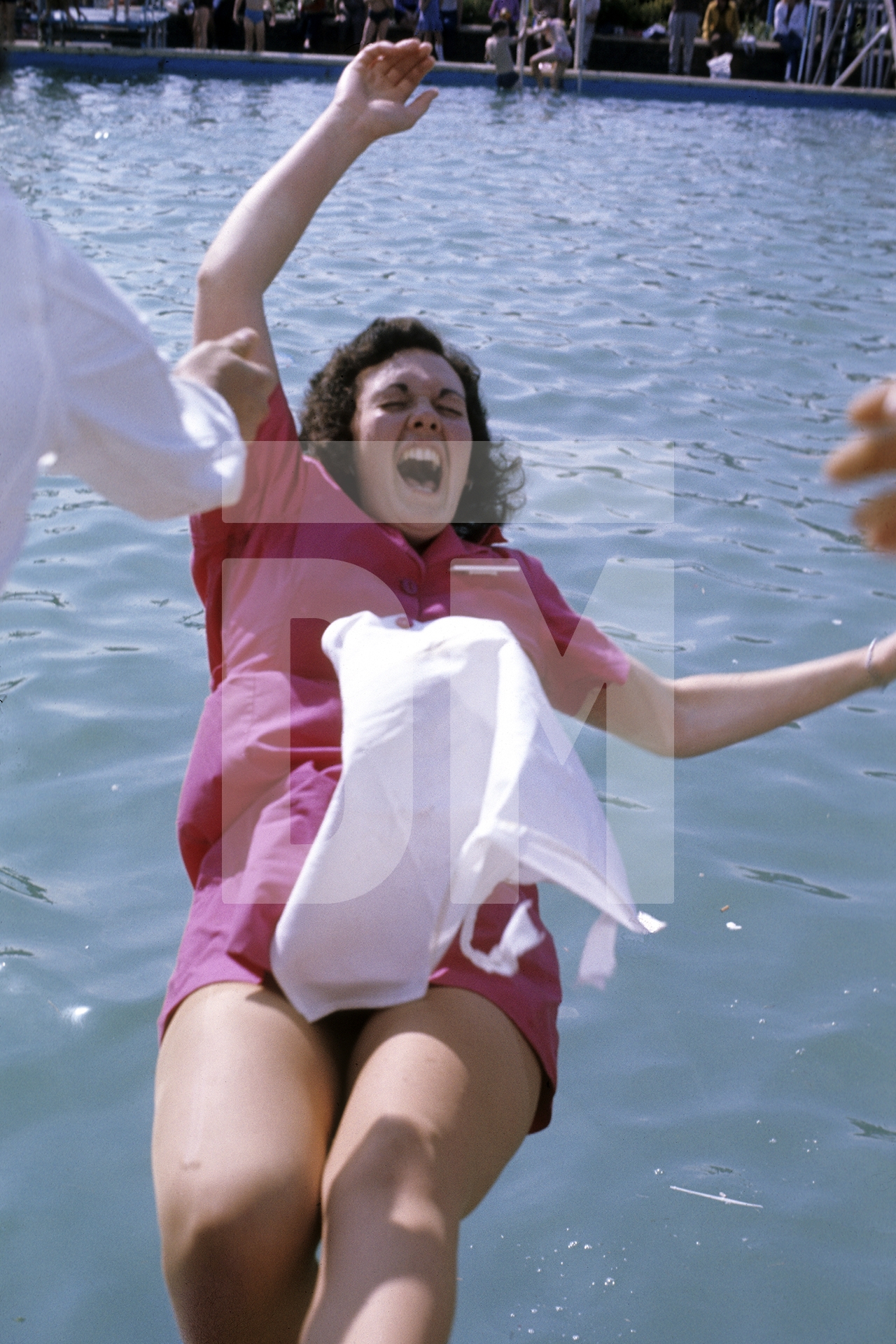 A chalet maid is pushed into the pool. Butlin’s Filey, Yorkshire. 1972 by Daniel Meadows