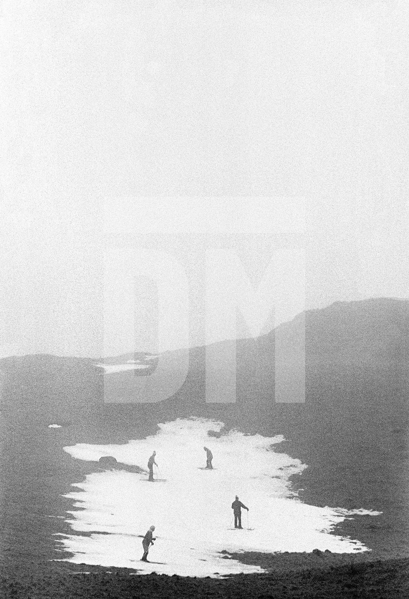 Skiing on remnants of snow during a thaw, Shap fell, Cumbria. January 1977 by Daniel Meadows