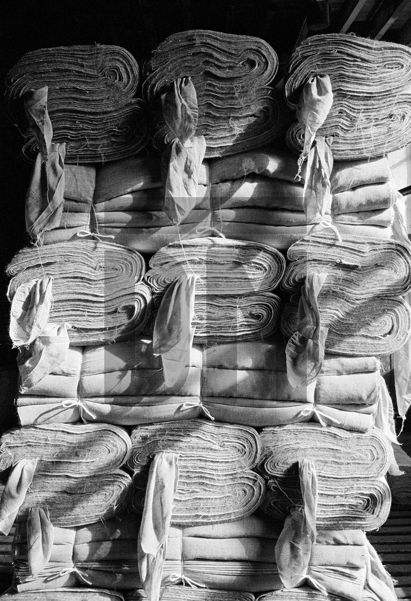 In the warehouse. Loom-state (‘grey’) cloth awaiting collection. April 1976 by Daniel Meadows