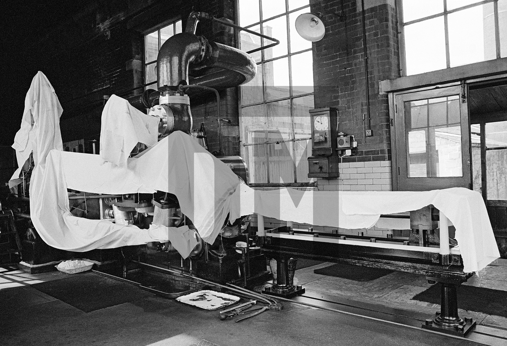 The engine house during wakes week. High pressure cylinder, conrods and tail slide covered with fent (waste cloth). July 1976 by Daniel Meadows