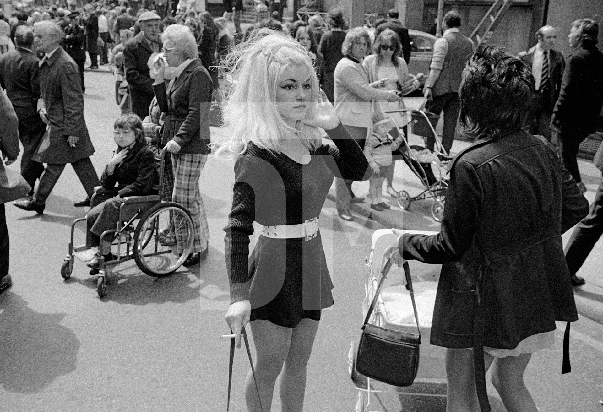 Crowd breaking up after watching city centre carnival procession, Manchester. Spring 1973 by Daniel Meadows