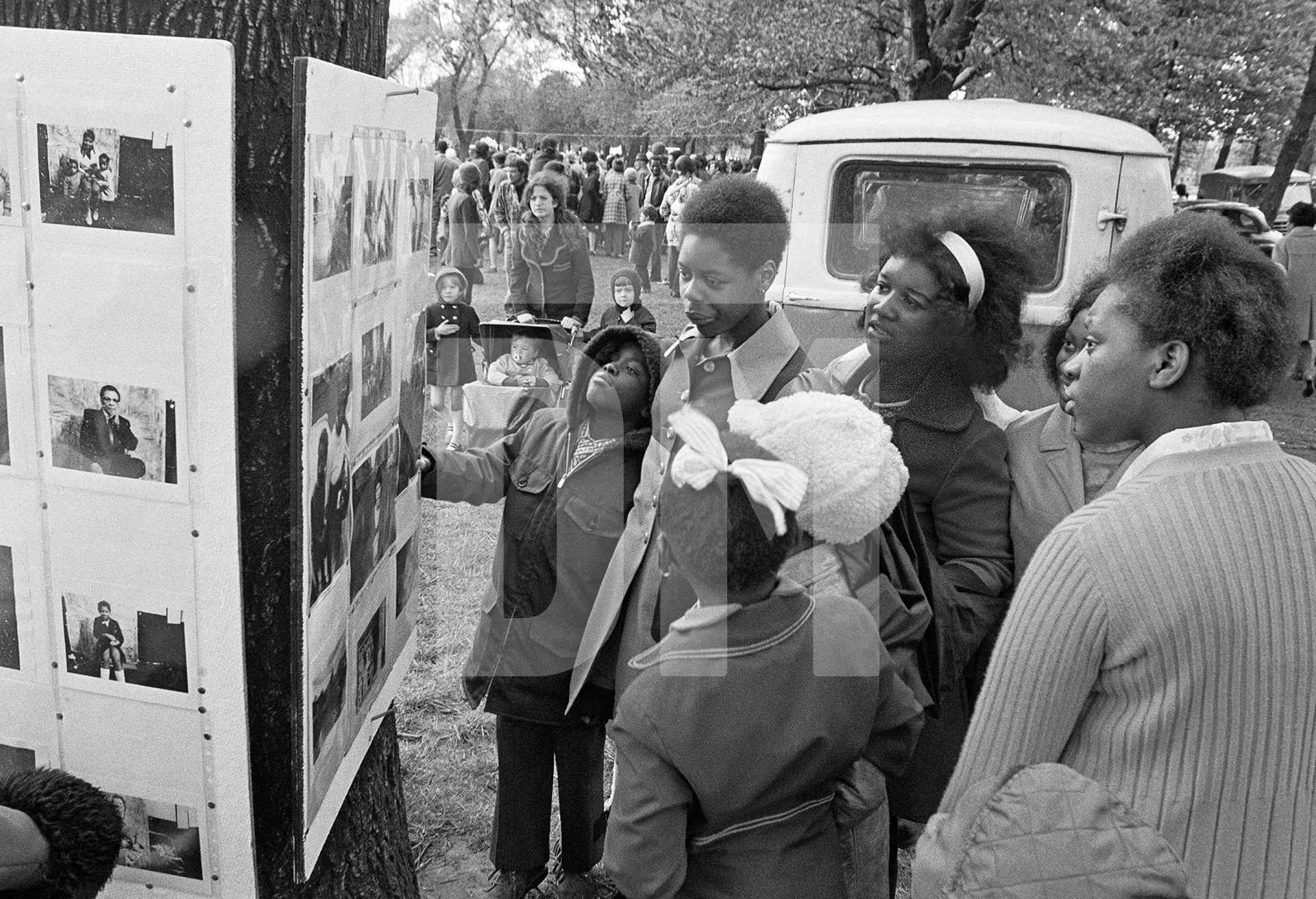Impromptu exhibition of portraits made in The Shop on Greame Street. Caribbean Carnival, Alexandra Park, Moss Side, Manchester. Whitsun Bank Holiday, 1972 by Daniel Meadows