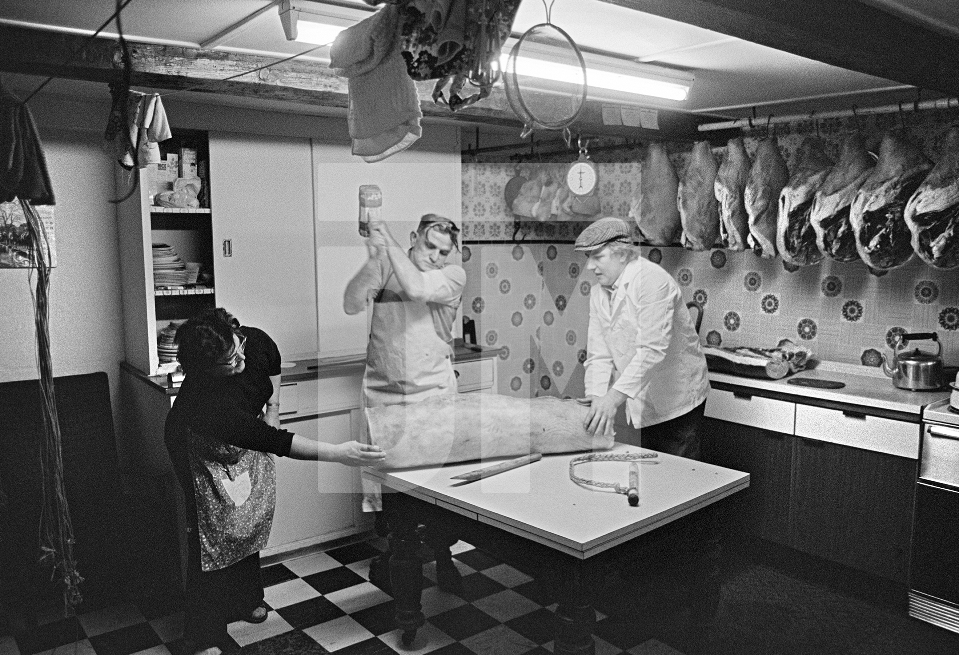 Bacon rolling. Cyril Richardson wields the mallet. North Yorkshire 1976 by Daniel Meadows