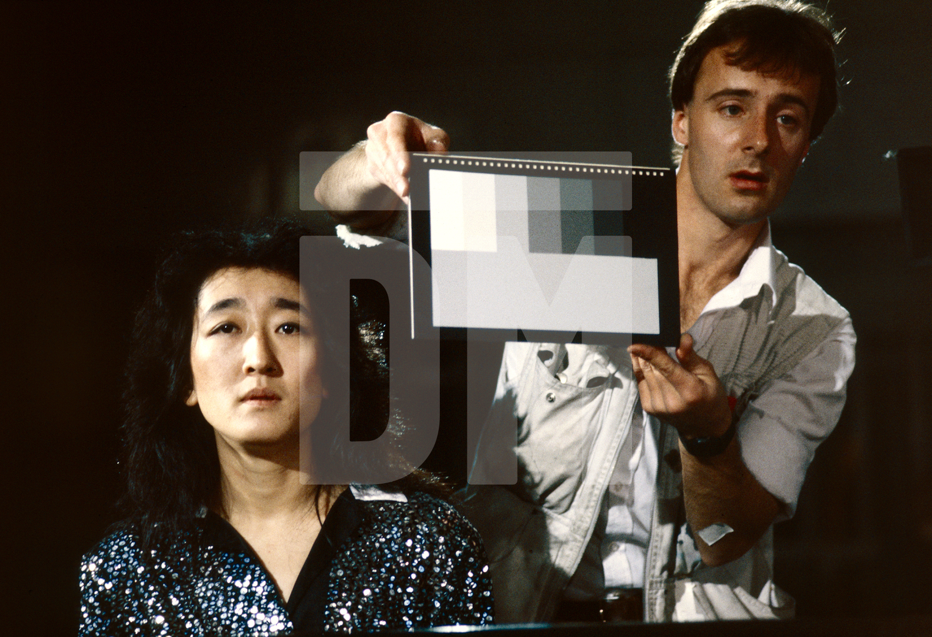 Mitsuko Uchida, with camera assistant, on the set of 'Mozart in Japan'. September 1986 by Daniel Meadows