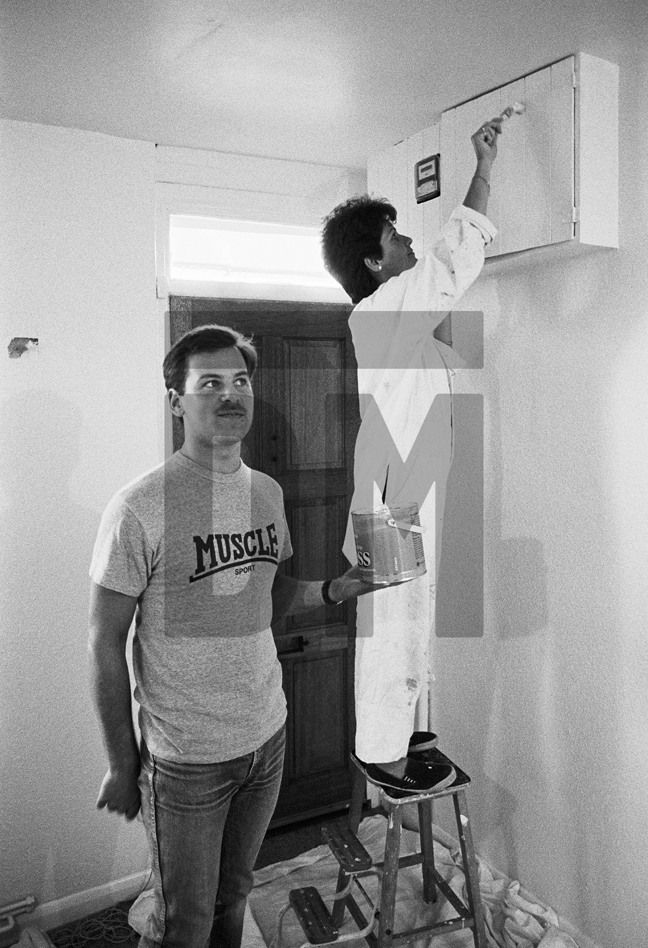 Decorating their first home, Napier Road, Bromley. July 1984 by Daniel Meadows