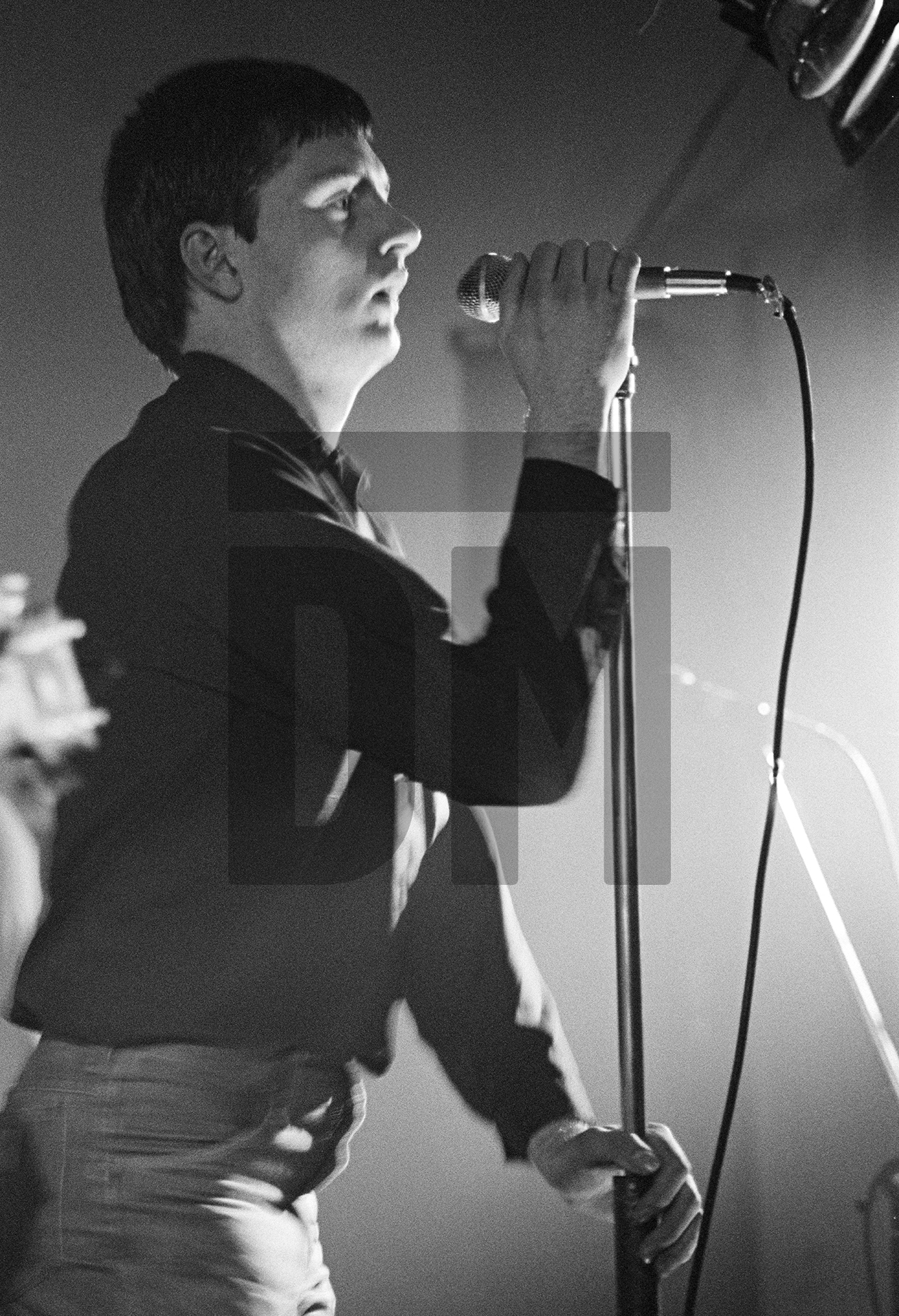 Ian Curtis of Joy Division on stage at New Osbourne Club, Miles Platting, Manchester. 7 February 1980 by Daniel Meadows
