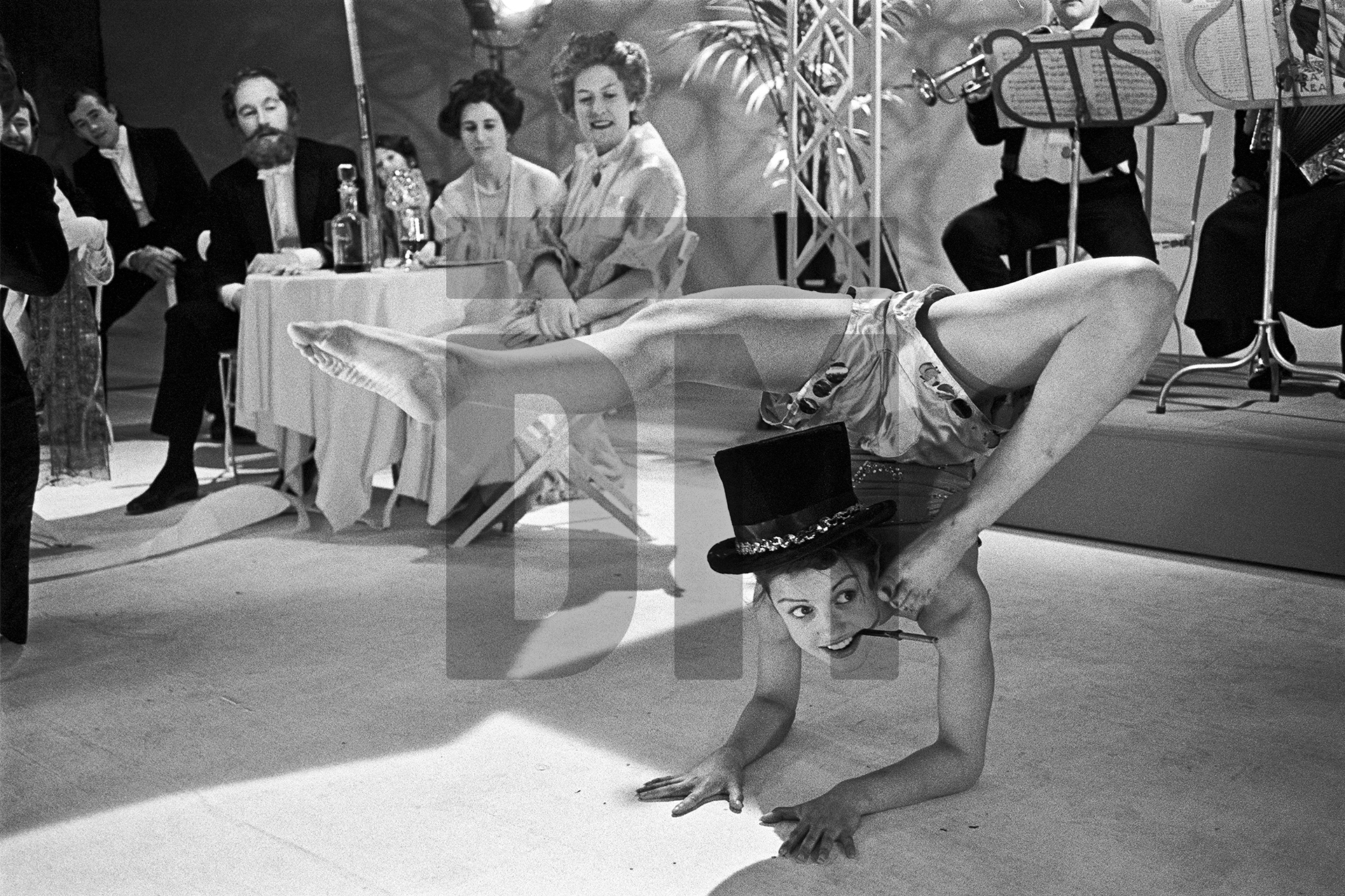 After dinner in Venice, travelling players entertain hotel guests. Location filming. Charing Cross Hotel, London. 15 June 1981 by Daniel Meadows