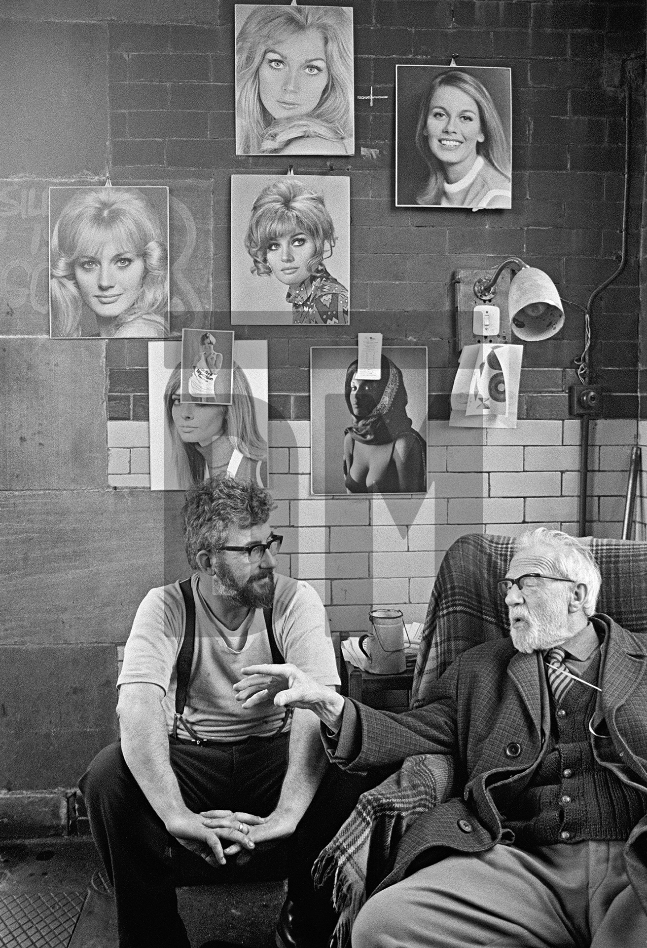 In the engine house. Stanley Graham, mill engineer in conversation with Dr. John Wilfred Pickard. 1976 by Daniel Meadows