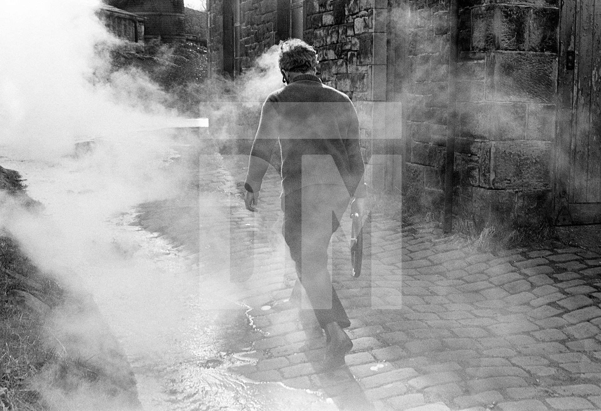 Stanley Graham, mill engineer, ‘blowing down’ (emptying) the Lancashire boiler ready for fluing. April 1977 by Daniel Meadows