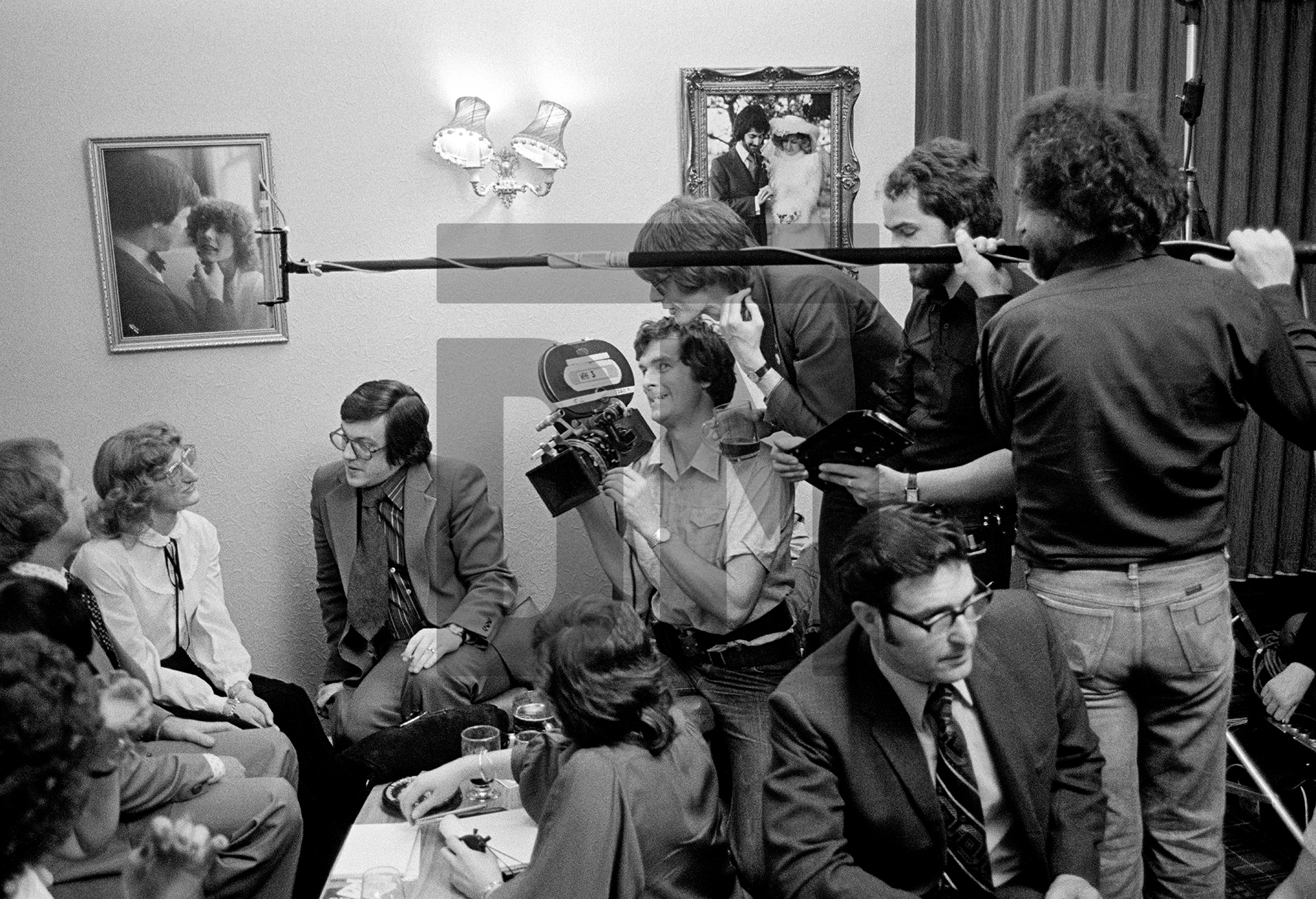 Filming on location, the ‘What’s On’ crew in a singles’ club, Mike Riddoch (in suit) conducts interview, David Liddiment directs, Manchester. April 1979 by Daniel Meadows
