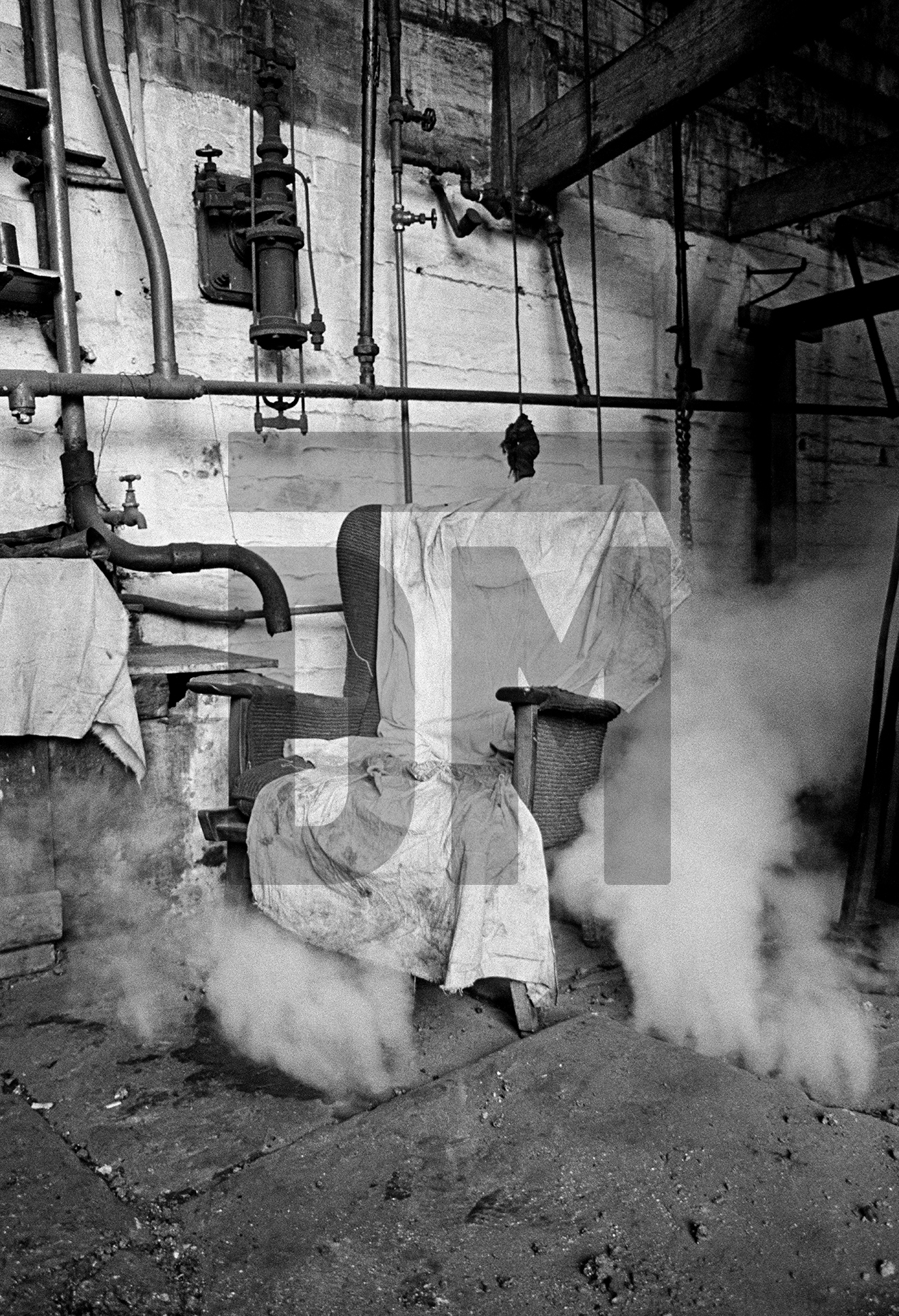 Boiler tenter’s (‘fire-beater’s’) chair during ‘blowing down’ of the Lancashire boiler (emptying it) ready for fluing. Wakes holiday, July 1976 by Daniel Meadows