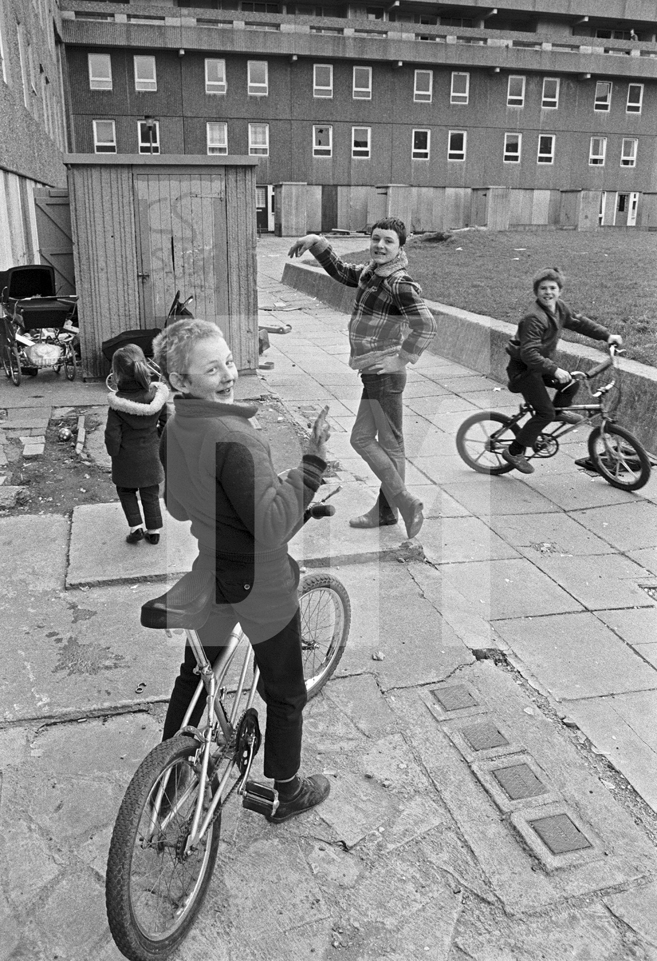 Life goes on while demolition takes place, Bessemer Park, Spennymoor, Co. Durham. February 1983 by Daniel Meadows