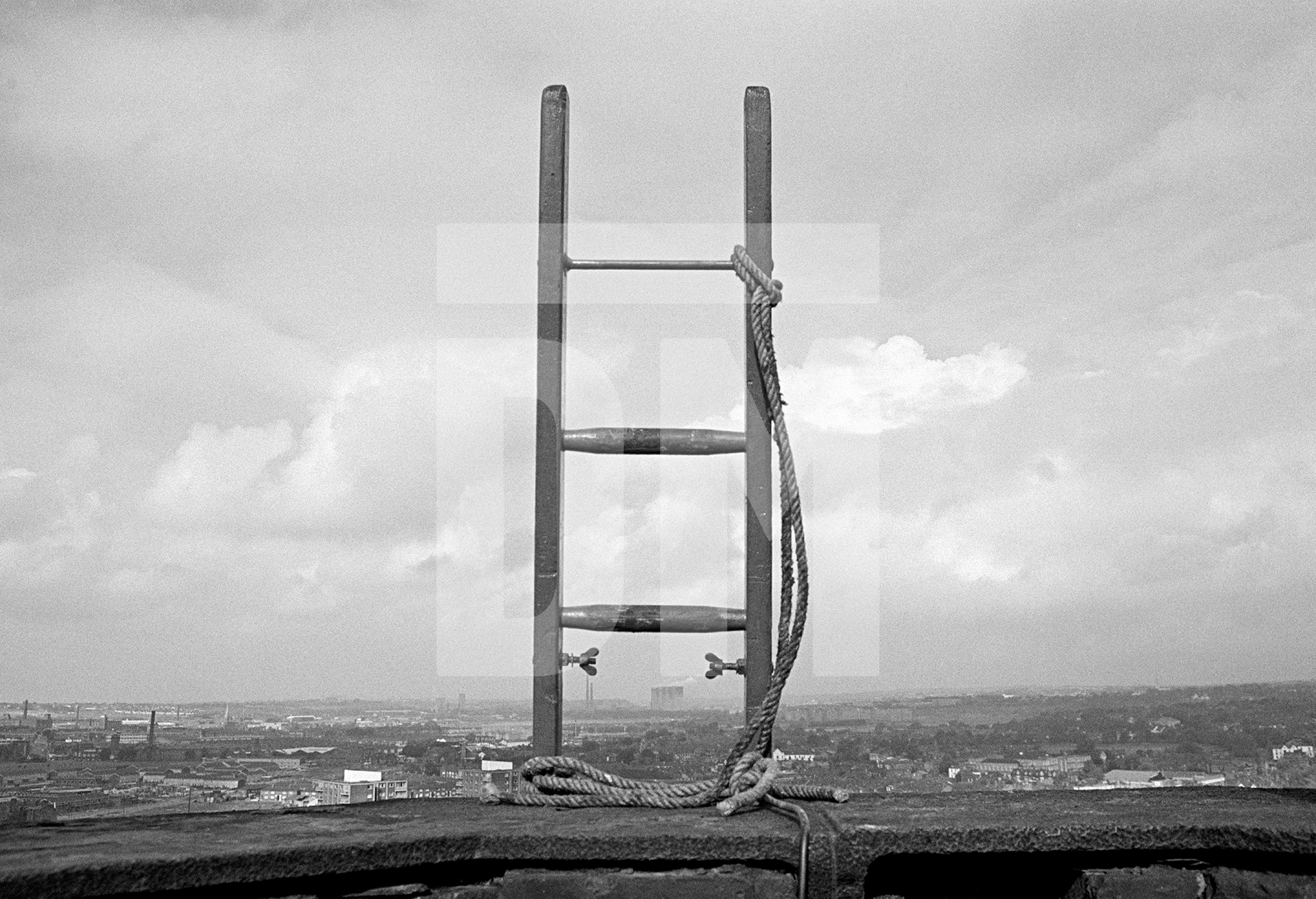 Prior to demolition the laddering is done. Here, 150 feet up, we see the top of the eleventh ladder, complete with lashings. September 1976 by Daniel Meadows