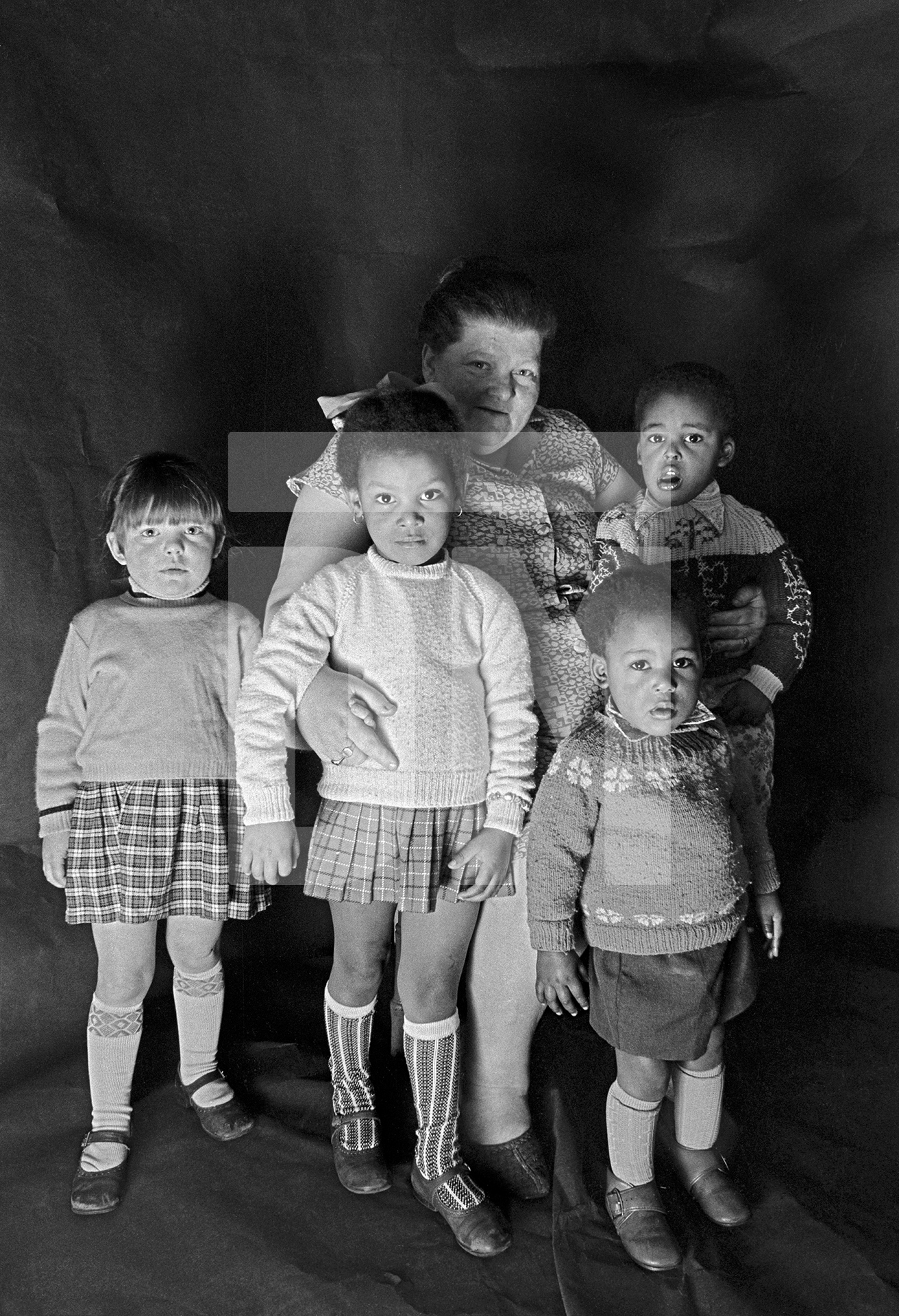 Foster mother with children. Group portrait from The Shop on Greame Street, Moss Side, Manchester. February-April 1972 by Daniel Meadows