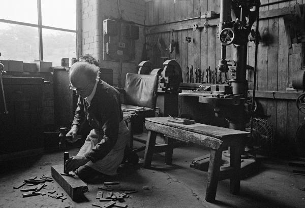 In the warehouse. Tackler (loom overlooker) in his workshop. May 1976