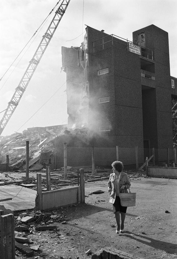 Life goes on while demolition takes place, Bessemer Park, Spennymoor, Co. Durham. February 1983