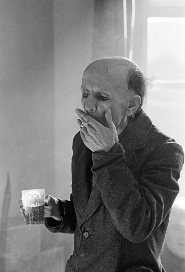 Derek Croley, aged 52 a former bus driver, enjoys a beer (5 tokens) and a cigarette (3 tokens). February 1978