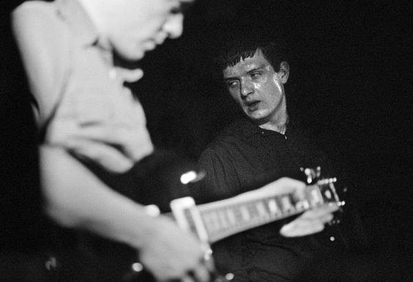 Bernard Sumner and Ian Curtis of Joy Division, on stage, New Osbourne Club, Miles Platting, Manchester. 7 February 1980