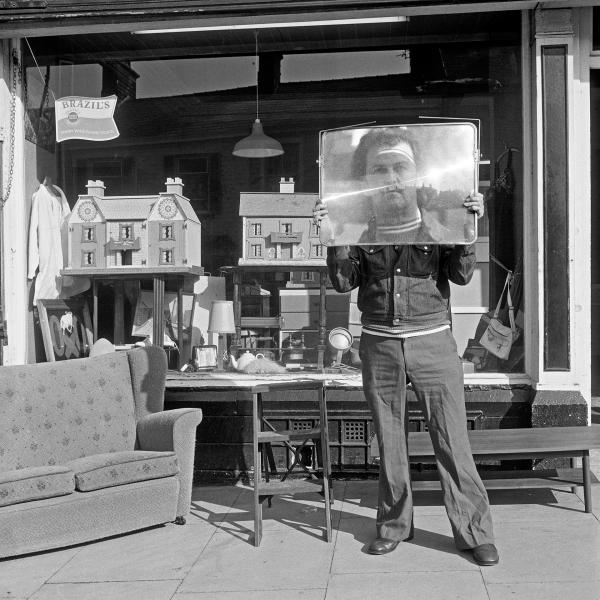 Second-hand goods shop with proprietor, Colne, Lancashire. November 1975