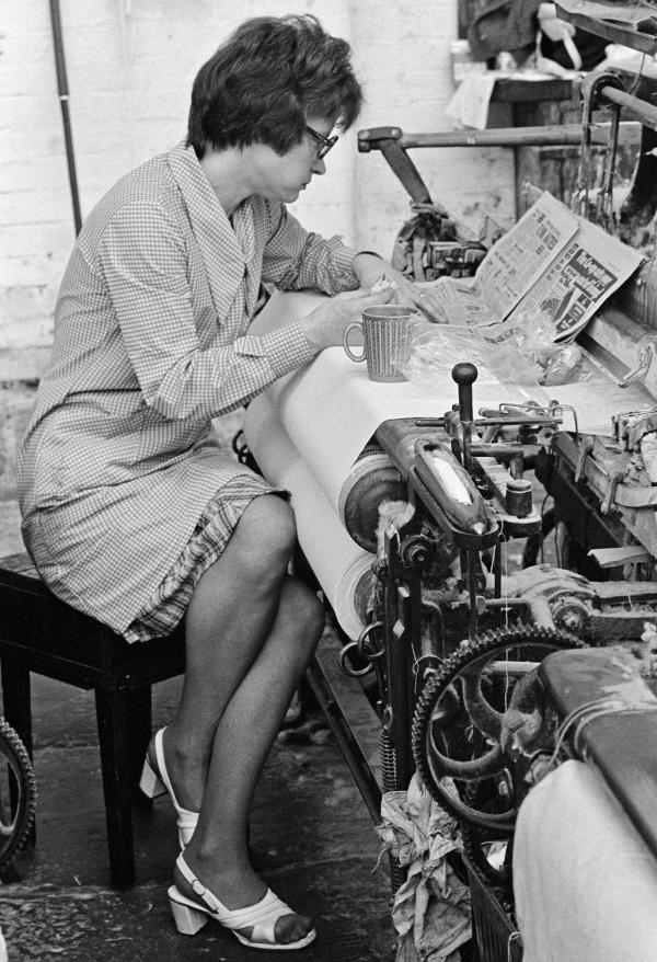 In the weaving shed, a weaver takes her break. May 1976