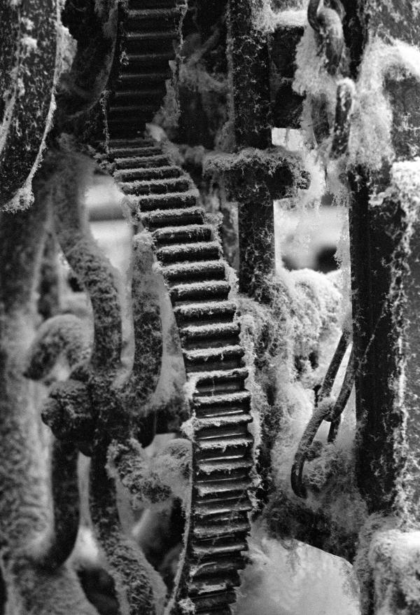 In the weaving shed, loom parts with cotton dust (‘dawn’). September 1976