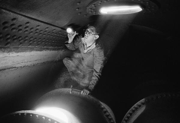 Insurance company boiler inspector on top of one of the furnace tubes inside the Lancashire boiler. Wakes holiday, July 1977