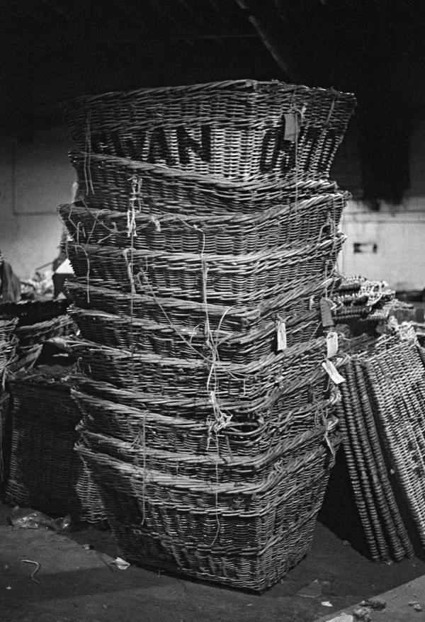 In the warehouse, stack of empty yarn skeps. January 1977