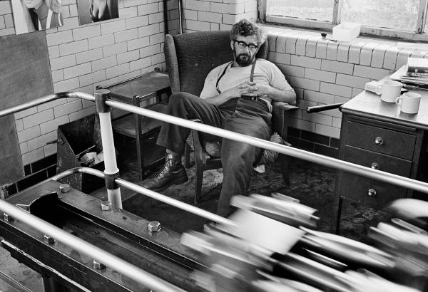 In the engine house. Stanley Graham, mill engineer, sleeping in his armchair beside the low pressure tail slide. May 1976