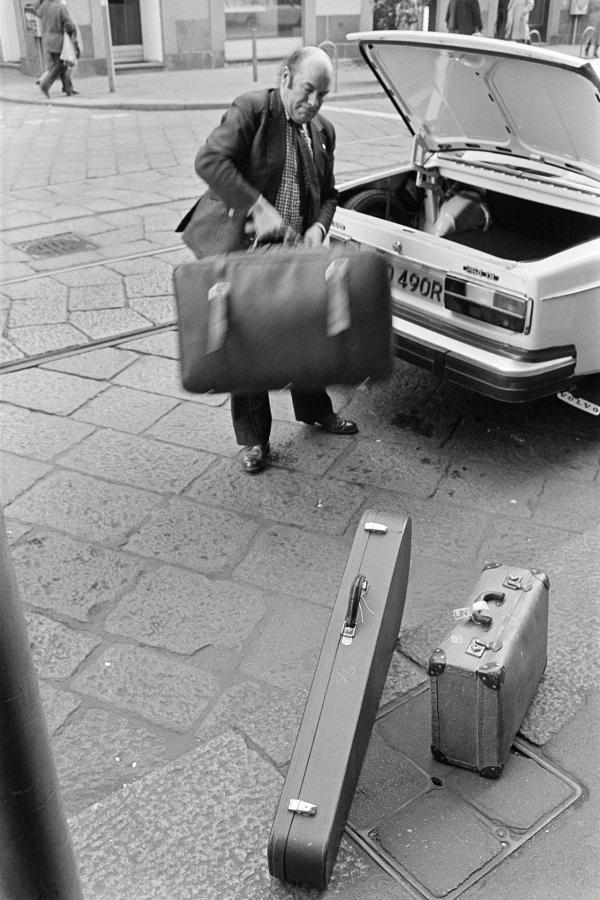 Julian Bream arriving at hotel and unpacking his car, Italy. March 1981
