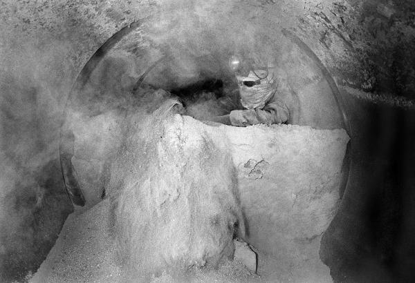Charlie Sutton in the furnace tube shovelling fluedust. Easter holiday, April 1976