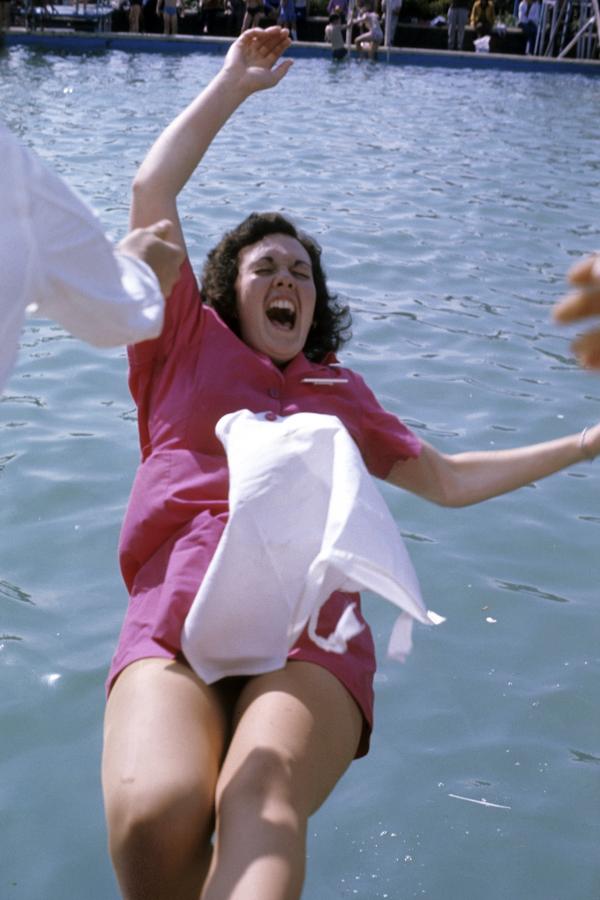 A chalet maid is pushed into the pool. Butlin’s Filey, Yorkshire. 1972