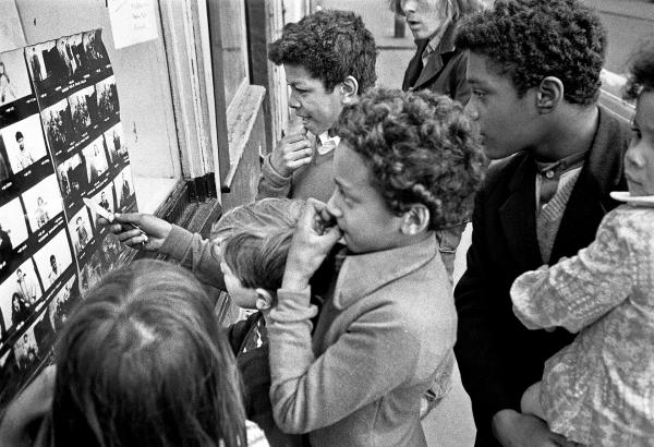 Looking at pictures in the window of The Shop on Greame Street, Moss Side, Manchester. February-April 1972