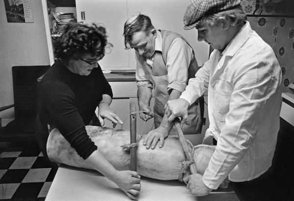 Elsie and Cyril Richardson with Tony Critchley (right) twitch up a bacon roll with twine. North Yorkshire 1976