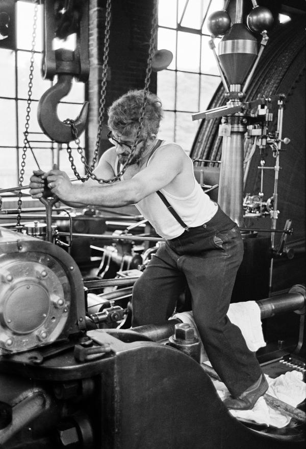 In the engine house. Stanley Graham, mill engineer. Maintenance, repairs to gland packing on high pressure cylinder. June 1976