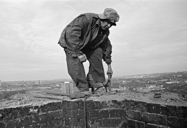 Atop the stack during demolition. September 1976