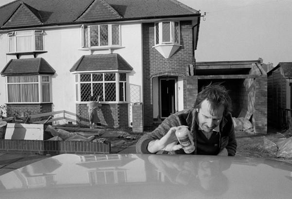 Polishing the car, cleaning windows. Hayes, Kent. February 1985