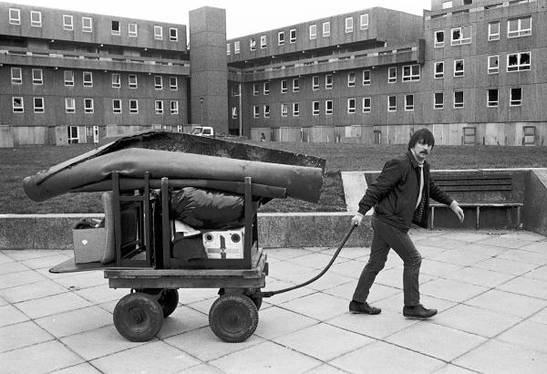 Life goes on while demolition takes place, Bessemer Park, Spennymoor, Co. Durham. February 1983