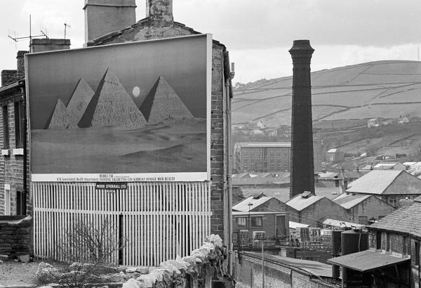 Pyramids, billboard, mill chimney, Colne Valley, West Yorkshire. April 1978