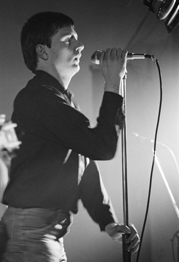 Ian Curtis of Joy Division on stage at New Osbourne Club, Miles Platting, Manchester. 7 February 1980